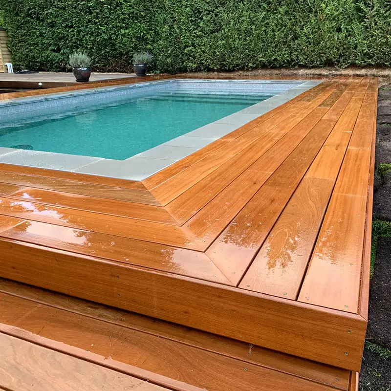 Timber pool decking surrounding a garden pool
